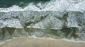 A beach with waves, sand, and water. - Vilano Beach Pool Home-Ocean Views (St. Augustine)