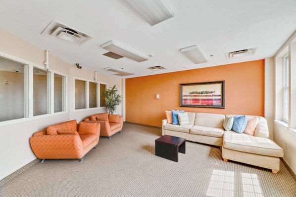 A spacious room with two sofas, a coffee table, and a large window providing natural light.