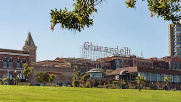 A building with a large sign reading "Ghirardelli" and a clock tower.