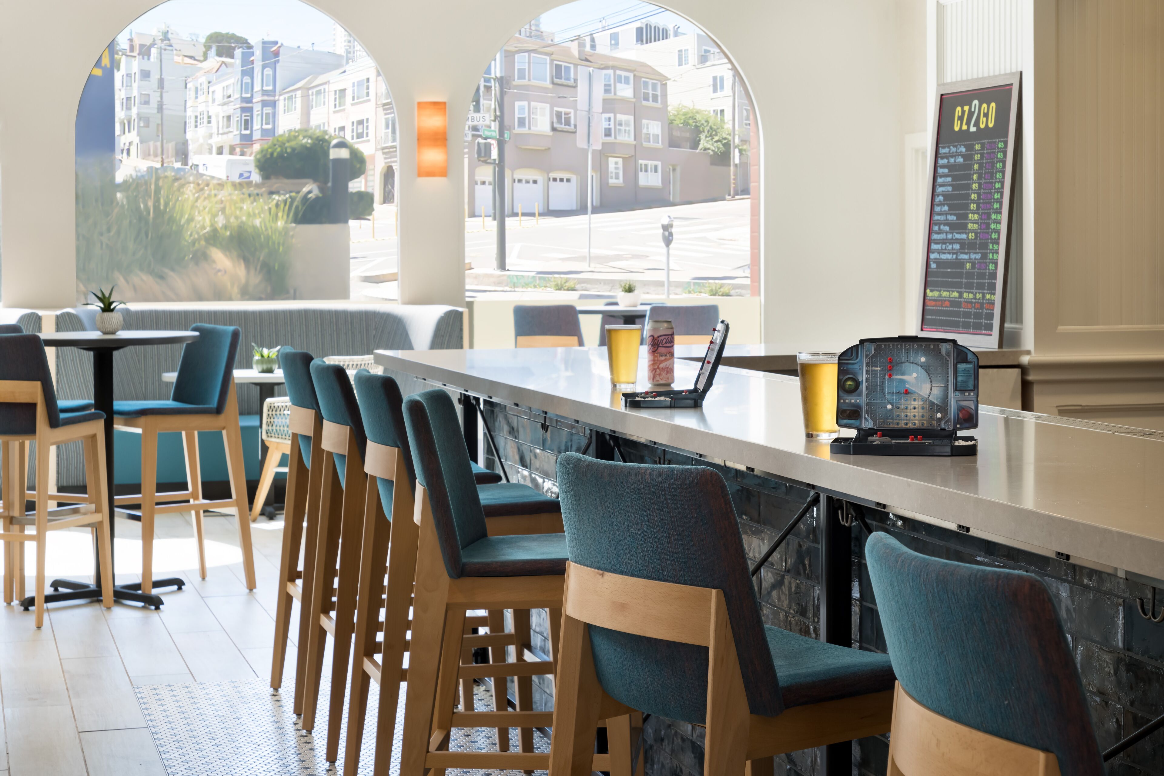 A bar area with wooden chairs and a high counter.