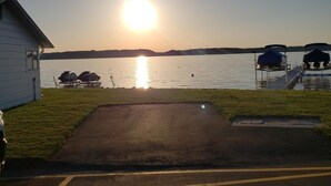 A parking area with a view of a lake and a sunset. - Come and enjoy beautiful Torch Lake! (Bellaire)