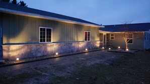 A single-story house with a stone foundation and a flat roof. - Come and enjoy beautiful Torch Lake! (Bellaire)