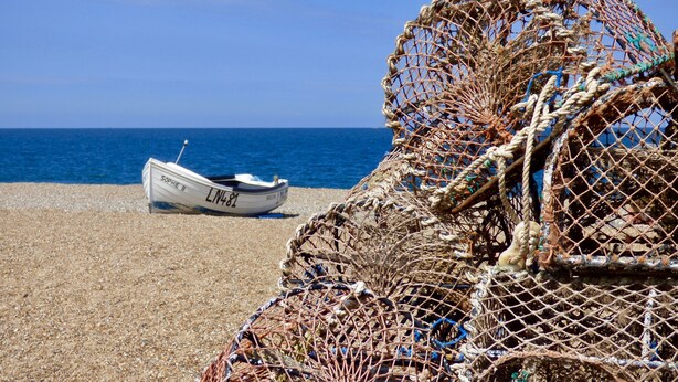 A boat named Sophie B on a pebbled beach with fishing nets and a clear blue sky. - Fo'c'sle, Wiveton, Norfolk (Wiveton)