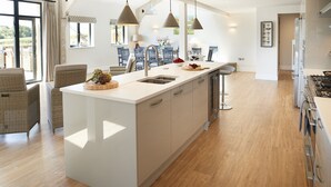 A modern kitchen with a central island, pendant lighting, and a view of the outdoors. - Bokes Barn, Hawkhurst , Kent (Hawkhurst, Cranbrook)