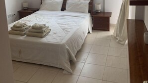A bedroom with a bed, bedside tables, a window with curtains, and a ceiling fan. - KINGS SUNSET, PAPHOS (Paphos)