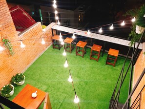 Enjoy dining and socializing in this secure outdoor patio area with tables and chairs.