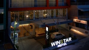 A modern hotel with multiple floors, large windows, and a prominent sign reading "WINSTAR HOTEL". - Winstar Hotel (Pekanbaru)
