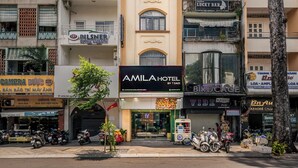 A multi-story hotel with balconies and a sign for 'AMILA HOTEL'. - SAZI AMILA Nguyen Hue HOTEL - Free Banh Mi (Ho Chi Minh City)