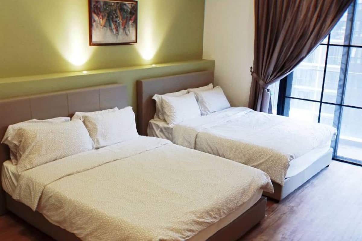 Two beds with white bedding in a room with a large window and a painting on the wall.
