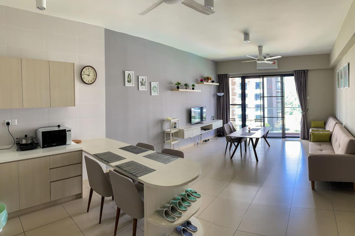 A modern living space with a kitchen, dining area, and seating area.