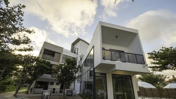 Un edificio residenziale moderno a più piani, con ampie finestre e tetto piano.