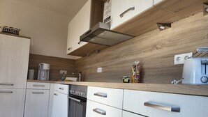 Private kitchen - Hühnergott Vacation Home with Sauna, Wood-Burning Stove, Terrace, and Garden - Vacation Homes (Breege)
