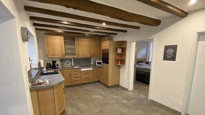 A kitchen with wooden cabinets, a countertop, and a built-in oven.