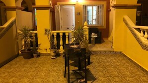 A courtyard with a tiled floor, potted plants, a grill, and a staircase. - Air-conditioned 2 bedroom villa in Orihuela Costa with pool and sea 1 km (Orihuela Costa)