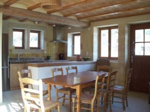 Enjoy cooking in this well-equipped kitchen with a central island, sink, and range hood.