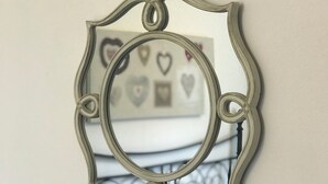 A decorative mirror with an ornate frame. - Swale Corner Home from Home (Wellingborough)