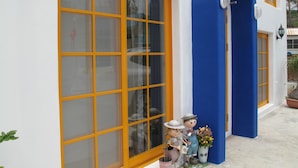 A building with large windows and a blue archway. - Peanut House (Hengchun)