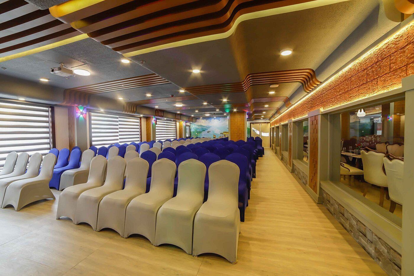 A row of seats with a wooden floor and a brick wall.