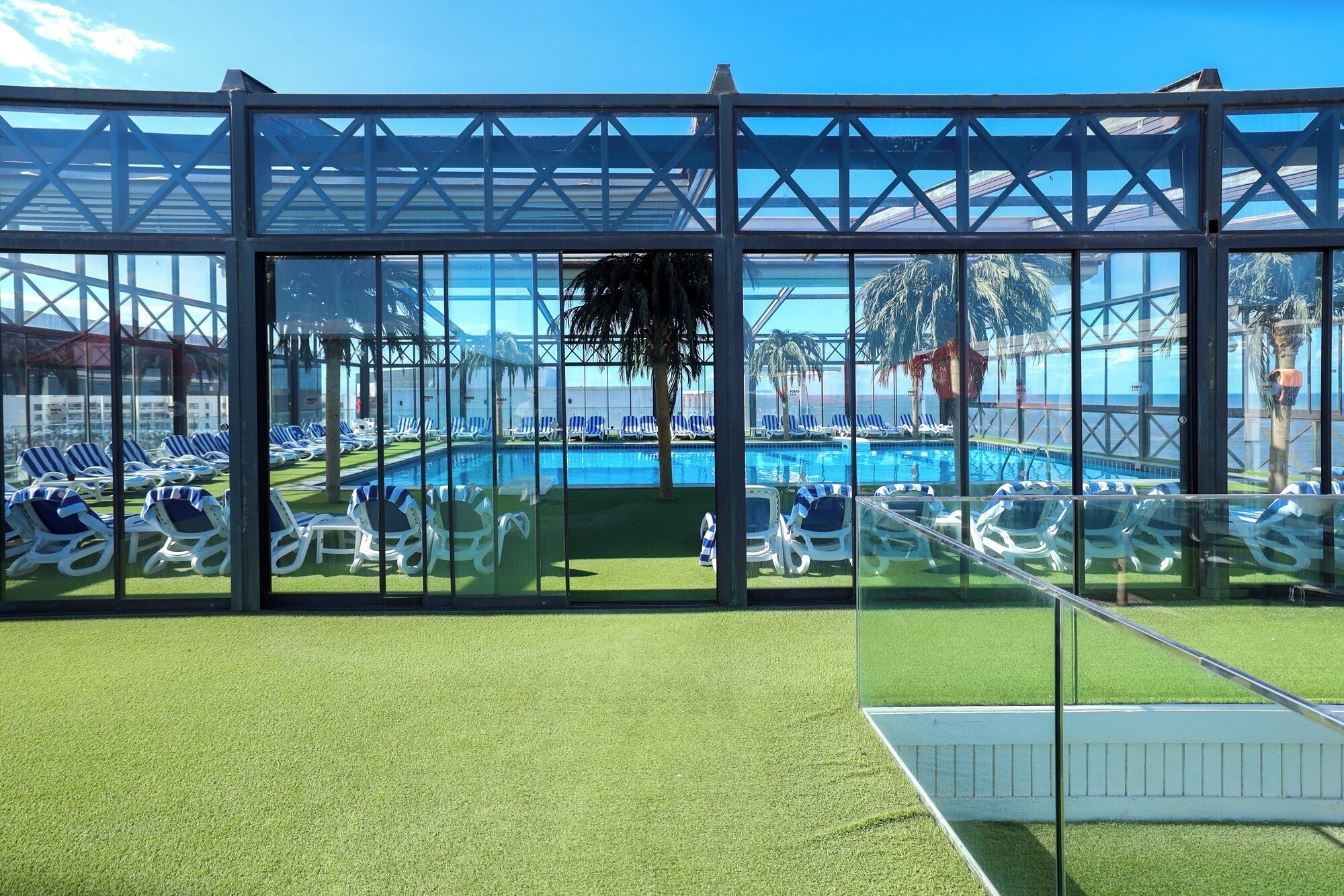 A poolside area with sun loungers and a clear view of the pool.