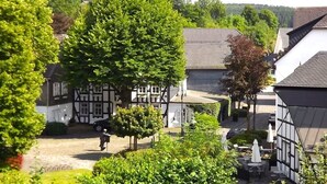 A traditional half-timbered building with a garden patio area.