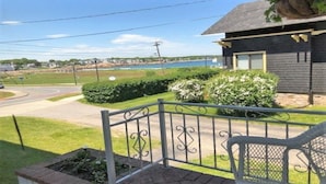 A residential property with a view of a lake, a paved driveway, and a well-maintained lawn. - ENDLESS VIEWS & Newly Updated!! (York)