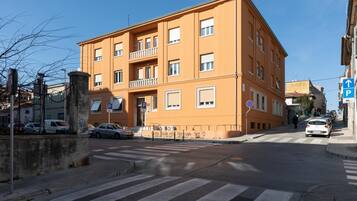A multi-story building with a flat facade, several windows, and balconies.