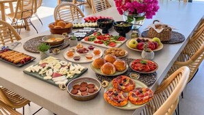 A dining table with various dishes and a view of the outdoors. - Carruba Boutique Hotel (Kas)