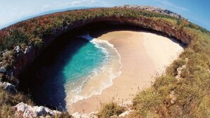 A beach with a natural arch formation.