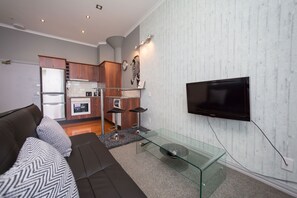 Apartment, 1 Bedroom | Living area | Flat-screen TV