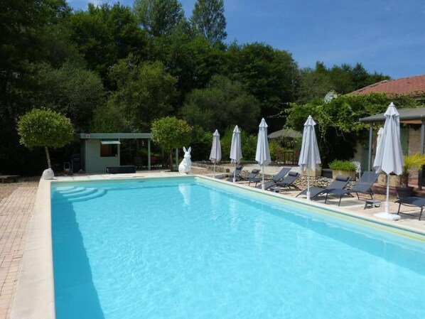 Seasonal outdoor pool, a heated pool, pool umbrellas, sun loungers