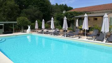 Seasonal outdoor pool, a heated pool, pool umbrellas, pool loungers