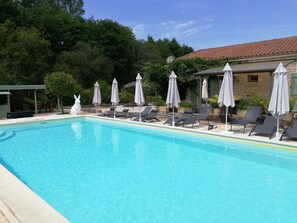 Seasonal outdoor pool, a heated pool, pool umbrellas, sun loungers