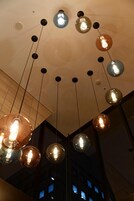 A ceiling with multiple hanging spherical light fixtures.