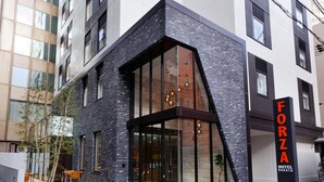 A modern hotel with a distinctive black and white facade, large glass windows, and a prominent 'FORZA HOTEL' sign. - Hotel Forza Hakataeki Hakataguchi (Fukuoka)