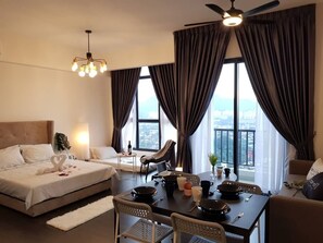 Relax in this stylish room with a large bed, dining area, and city views.