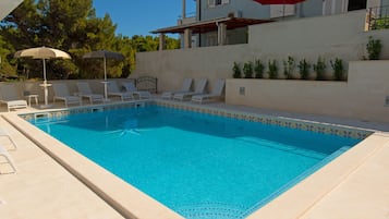 Seasonal outdoor pool, open 9:00 AM to 10:00 PM, pool umbrellas