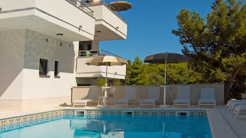 Seasonal outdoor pool, open 9:00 AM to 10:00 PM, pool umbrellas