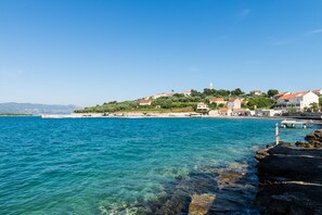 A coastal town with buildings on a hillside overlooking the sea. - VENUS PALACE Golden Gate rooms (Lumbarda)