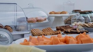 A buffet table with various food items including pastries, waffles, and fruit. - B&B da Patty (Affi)