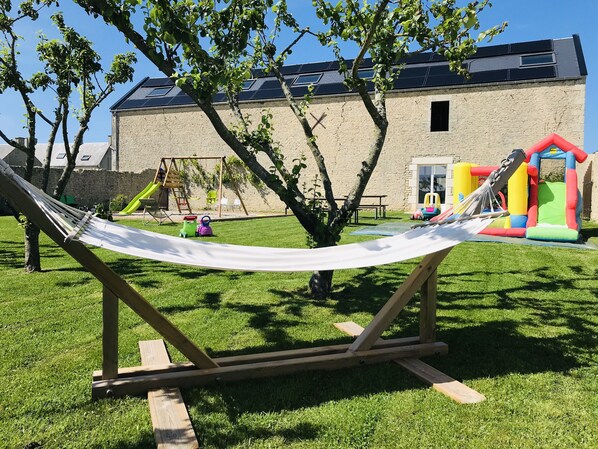 Relax in a serene outdoor space with a hammock and play areas for the whole family.