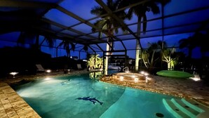 An indoor swimming pool with clear water, a hot tub, and lounge chairs. - A beautiful spot to unwind, relax and enjoy quality time with family and friends (Cape Coral)