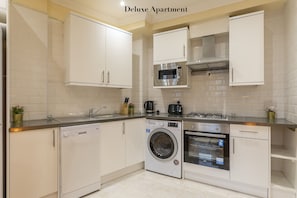 디럭스 아파트, 전용 욕실, 시내 전망 | 공용 주방 | 식탁