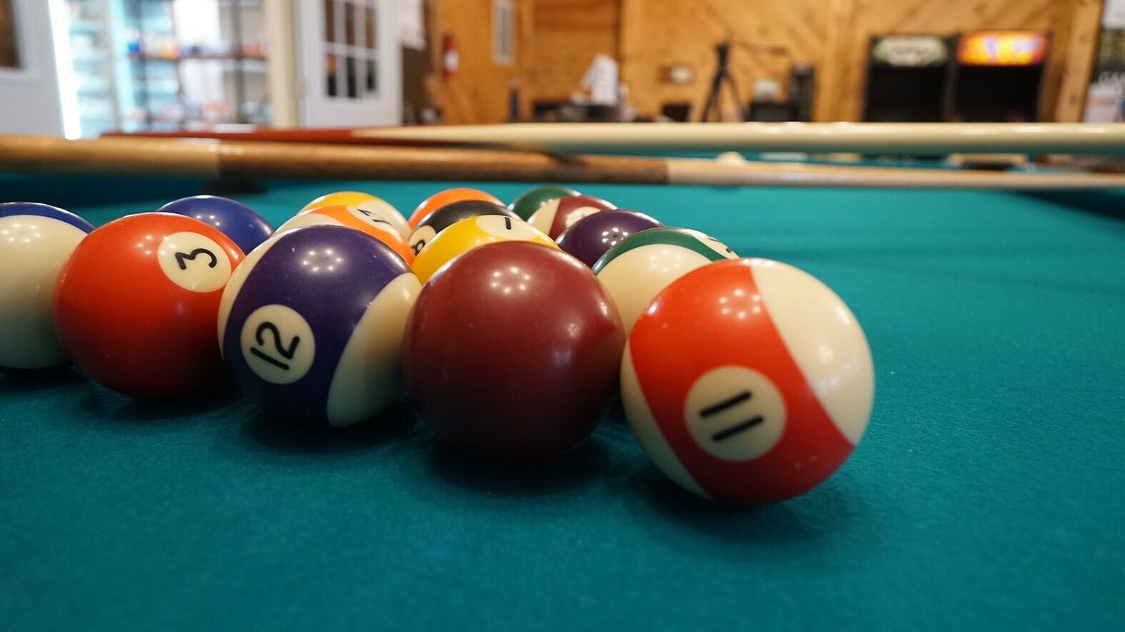A pool table with a variety of colored billiard balls.