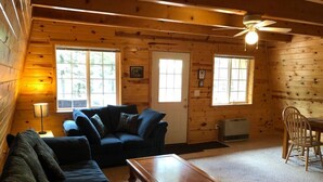 A cozy cabin interior with a wooden interior, a sofa, a coffee table, and a dining area. - Balcony, 20 min to Yellowstone, Sled/ATV Spot (Island Park)