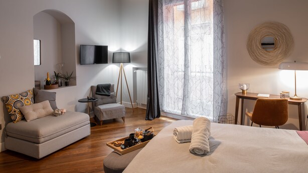 Une chambre d’hôtel moderne équipée d’un canapé, d’un lit, d’un bureau et d’une chaise.