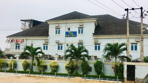A hotel with a light blue facade, multiple windows, and a sign that reads "EUC HOTEL". - Euc Demodern Hotel & Suites (Lagos)