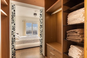A hotel room with a bed, a view of the city, and a closet with towels. - THE Most Incredible View IN Malta, INC Pool (Sliema)