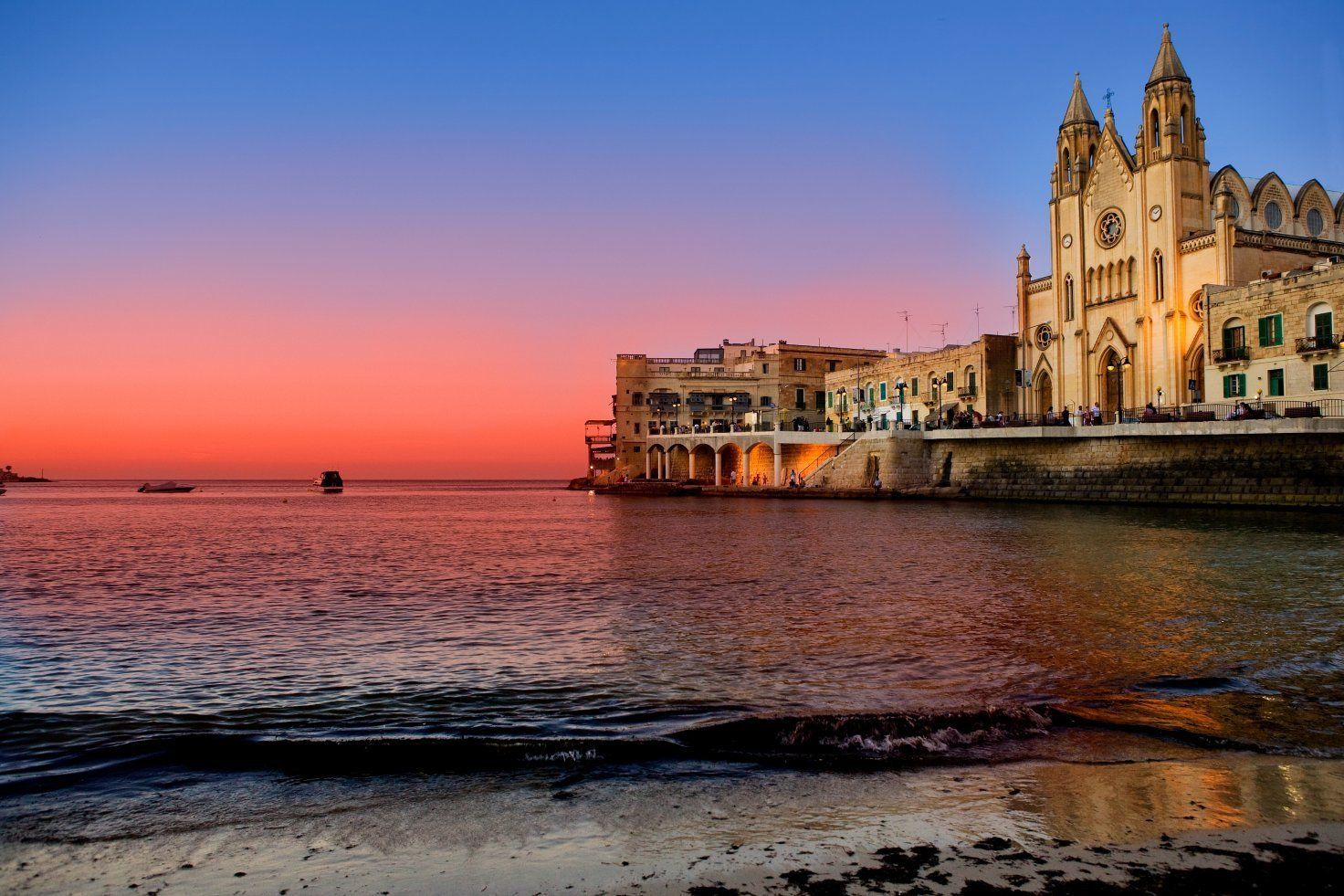 A waterfront view with a prominent church and a bridge.