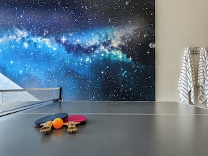 Experience the magic of the night sky in this room, where a starry mural sets the scene for fun and relaxation. Enjoy a game of table tennis or unwind with a fresh towel.