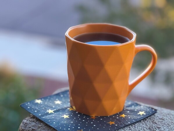 En kaffekopp på en underlägg med ett stjärnmönster.
